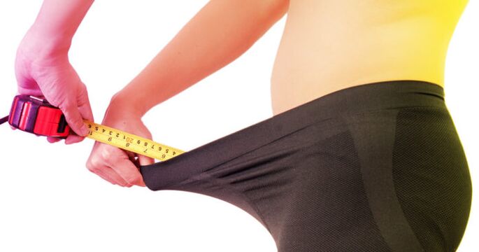 man measuring penis before enlarging